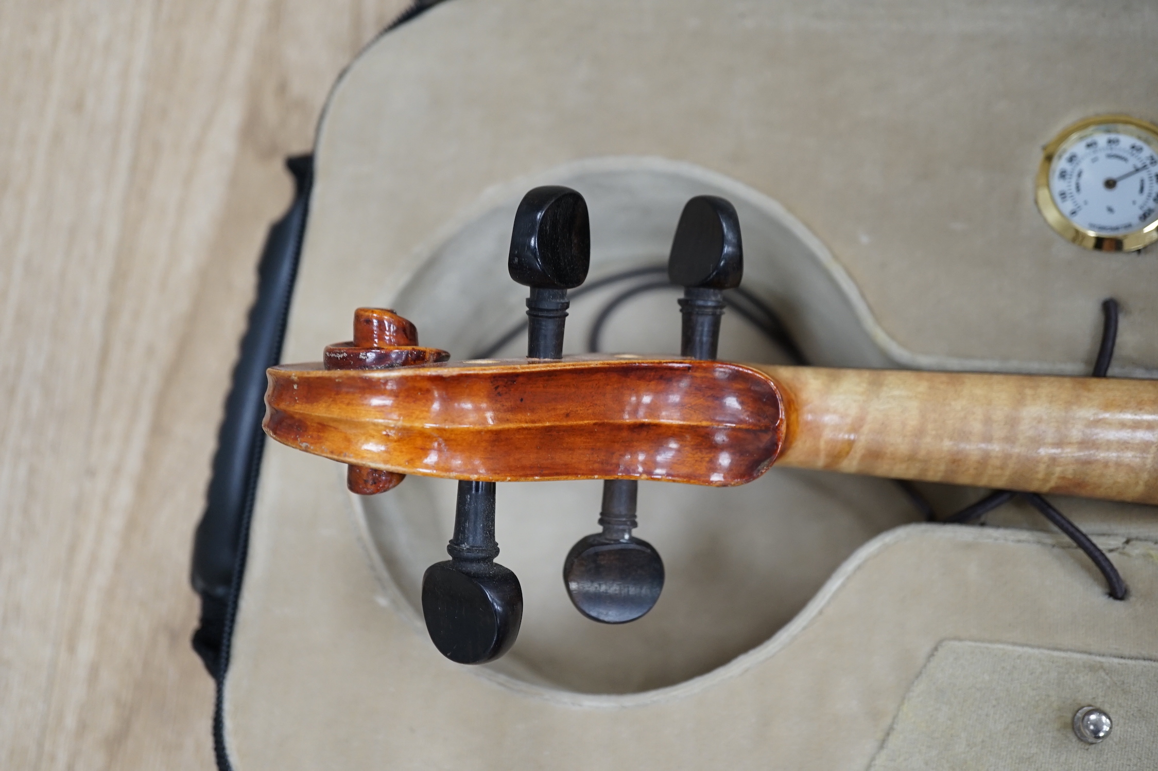 A Czechoslovakian student’s violin with Stradivarius label inside the body, length of body, 35.5cm, in a good modern case with fitted hygrometer